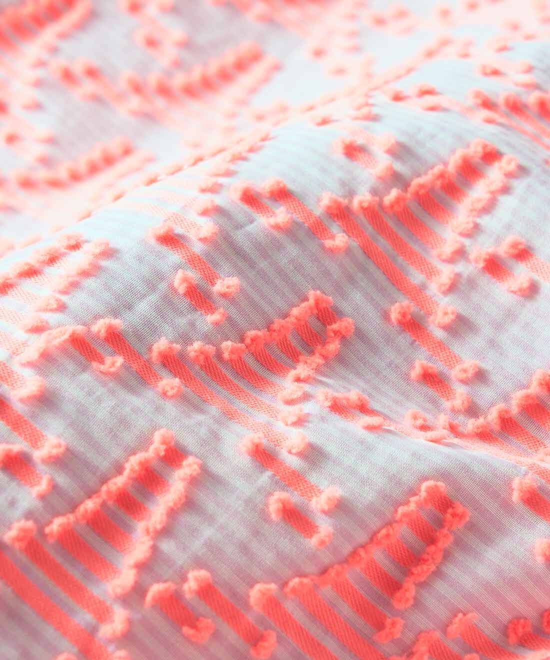 SeeMONO[シーモノ］|ジャカード織生地で作ったキャラメルみたいな形のポーチ〈ＰＩＮＫ　ＴＲＩＡＮＧＬＥ×ＧＲＥＥＮ　ＳＴＲＩＰＥ〉|透け感のある白と淡いピンクのボーダー地に並ぶ蛍光ピンクのタワーのような三角形のデザインのジャカード織生地。