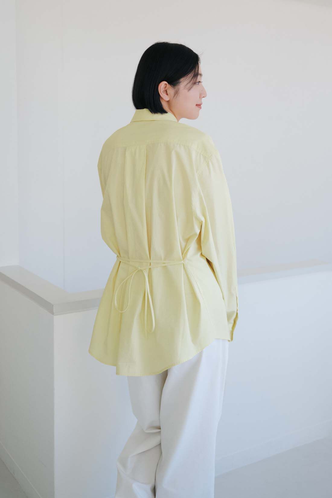 THREE FIFTY STANDARD［スリーフィフティースタンダード］|THREE FIFTY STANDARD　小谷 実由さんと作った こだわりの薄黄色シャツ〈イエロー〉|ベルトループに通した共布のリボンを後ろで結んで、シルエットを変えられます。