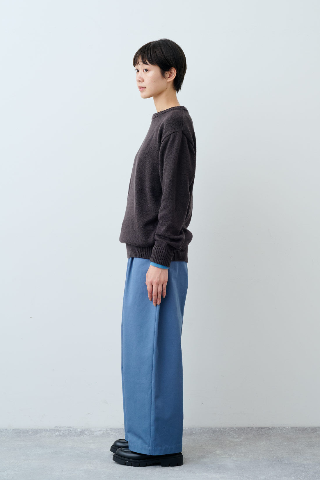 THREE FIFTY STANDARD［スリーフィフティースタンダード］|ふんわり無撚糸のコットンセーター〈ダークブラウン〉とフライス編みのストレッチラグランスリーブTシャツの会とグレイッシュブルーのタックワイドパンツのコーディネート|モデル身長：163cm 着用サイズ：M