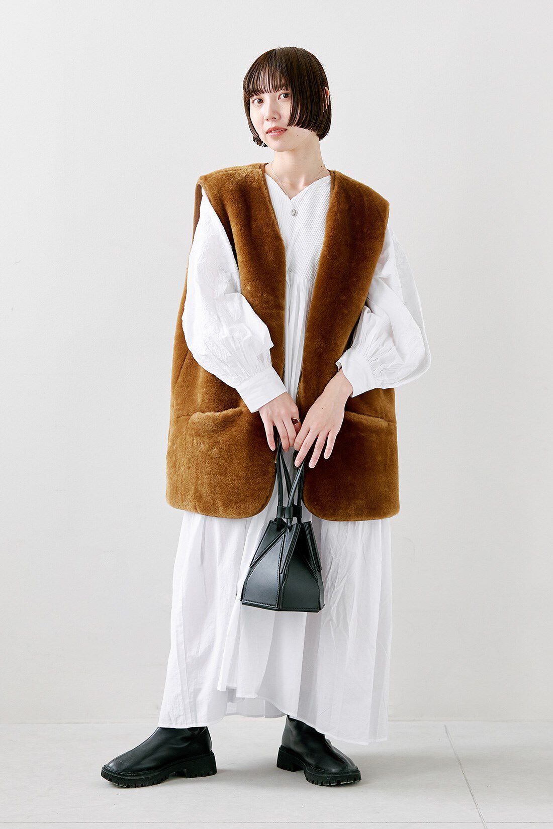 フェリシモファッションニュース|リバーシブルフェイクファーベスト〈アンバーブラウン〉と【MADE IN INDIA COLLECTION】モチーフ刺しゅうコットンワンピース〈ホワイト〉のコーディネート|【着用サイズ】ベスト：M　ワンピース：１（MP〜LP）
